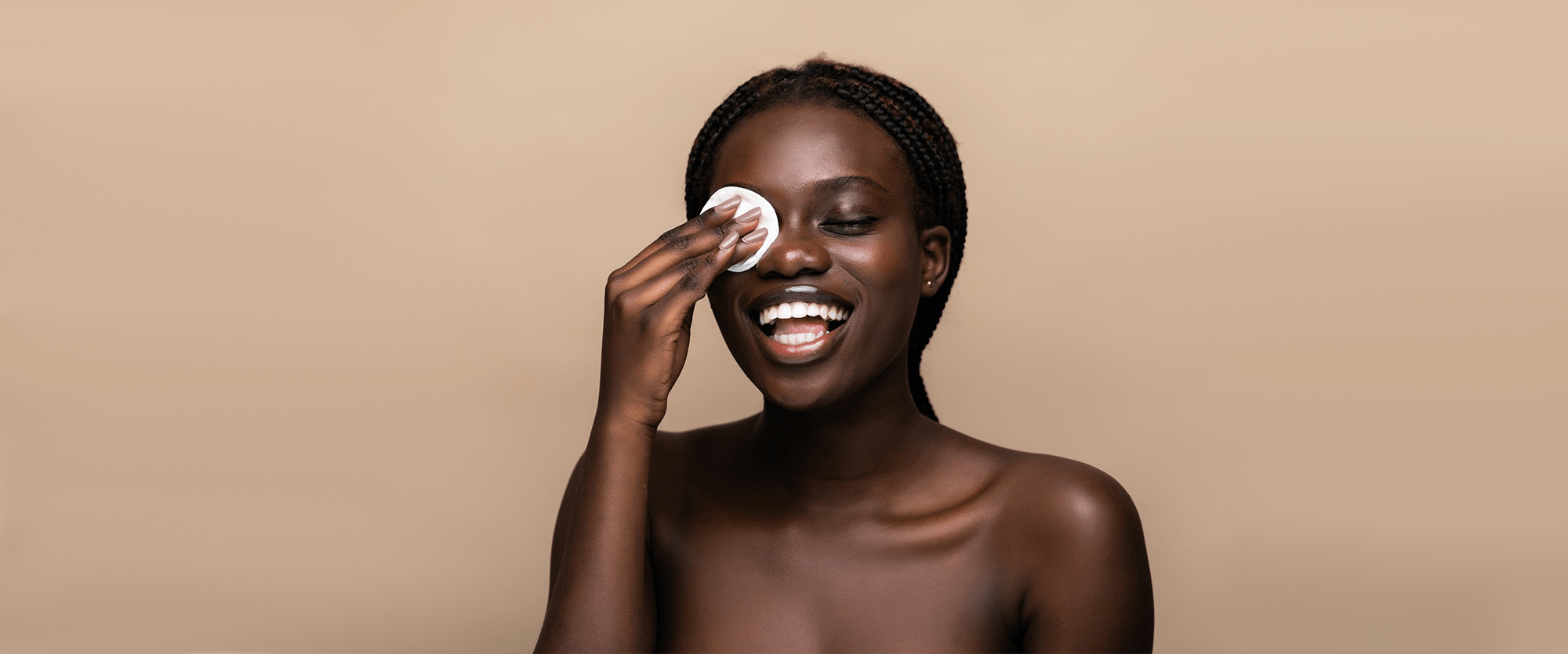 Woman using a pad to remove makeup from her eye.